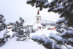 Snowy landscape and the typical church Maloja Canton of Graubünden Engadine Switzerland Europe