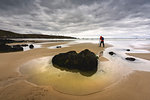 Photographer in Trespasses Bay in Cléden-Cap-Sizun at Dawn, Finistère, Bretagne, France.