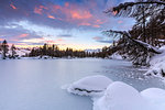 The pink clouds frame the frozen Lago Azzurro at dawn Spluga Valley Province of Sondrio Valtellina Lombardy Italy Europe