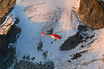 Helicopter in flight on glacier of Monte Disgrazia, Valmalenco, Val Masino, Valtellina, Lombardy, province of Sondrio, Italy