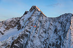 Helicopter in flight on the north face of Monte Disgrazia, Valmalenco, Val Masino, Valtellina, Lombardy, province of Sondrio, Italy