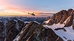 Aerial view of helicopter in flight towards Piz Roseg at sunset, Bernina Group, border of Italy and Switzerland