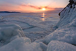 Ice stalactites in a cave at the shore at sunset at lake Baikal, Irkutsk region, Siberia, Russia