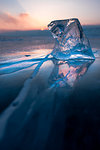 A cube of ice on the flat frosen lake at sunset, Baikal, Irkutsk region, Siberia, Russia