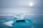 Piece of ice with sun reflection at lake Baikal, Irkutsk region, Siberia, Russia