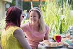 Affectionate lesbian couple enjoying lunch on patio