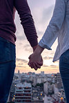 Couple standing on terrace and looking at cityscape