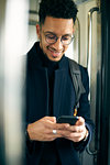 Smiling businessman using smartphone