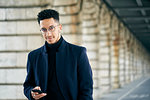 Portrait of businessman holding smartphone