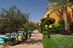 Beautiful garden at hotel resort and building in traditional arabic style. Resort architecture in Egypt.