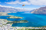 Aerial view of Queenstown, paraglider, Lake Wakatipu and The Remarkables mountains, Queenstown, Otago, South Island, New Zealand, Pacific