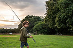 Boy with fishing rod, Bournemouth, UK