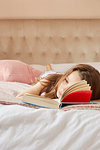 Girl reading book and day dreaming