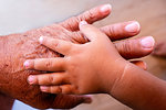 Hand of baby on man's hand