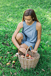 Woman picking up apples on grass