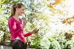 Young woman using smartphone in park