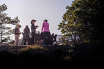 Friends talking at dinner on cliff top, Johnstone Strait, Telegraph Cove, Canada