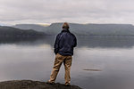 Man relaxing by lakeside, Johnstone Strait, Telegraph Cove, Canada