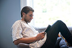 Man using digital tablet on sofa