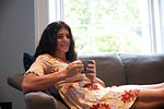 Woman with coffee mug on sofa