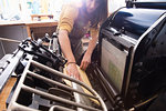 Woman preparing printer in shop