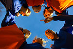 Girls soccer team listening to coach in huddle