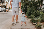 Man with toddler daughter on street