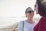 Affectionate lesbian couple on sunny beach