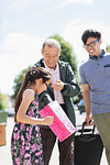 Grandfather visiting family, surprising granddaughter with gift