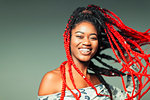 Portrait confident, carefree young woman with red braids