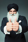 Portrait enthusiastic well-dressed senior man wearing turban, gesturing thumbs-up