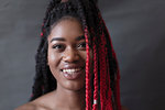 Portrait smiling, confident young woman with red braids