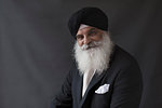 Portrait confident, well-dressed senior man with beard in turban