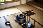 Traditional Japanese Tea Ceremony, high angle view of water container and small stand with a Hishaku, a bamboo ladle, on a tatami mat.
