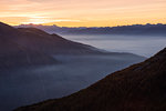 Silhouettes of the Orobie Alps in the mist of autumnal sunset, Valmalenco, Valtellina, Lombardy, Italy, Europe