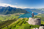 Hiker on top of Monte Berlinghera looks towards Colico and Monte Legnone, Sondrio province, Lombardy, Italy, Europe