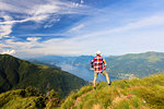 Hiker on Monte Legnoncino admires Lake Como, Lecco province, Lombardy, Italy, Europe