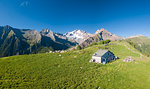 Panoramic aerial view of hut on green meadows, Scermendone Alp, Sondrio province, Valtellina, Rhaetian Alps, Lombardy, Italy, Europe