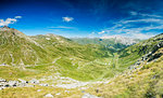Panoramic of winding road and green valley towards the village of Splugen, Spluga Pass, canton of Graubunden, Switzerland, Europe