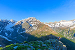 A hiker looks at Mount Disgrazia from above, Chiareggio valley, Valmalenco, Valtellina, Lombardy, Italy, Europe