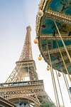 Eiffel tower with a classic carousel in the foreground early in the morning, Paris, France, Europe
