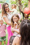 Mother with children at birthday party in park