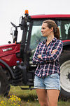 Agricultural worker standing in front of tractor