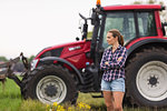 Agricultural worker standing in front of tractor