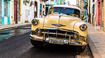 A vintage American car in a typical street in Havana, Cuba, West Indies, Caribbean, Central America