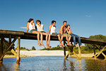 Group of young people sitting on jetty