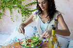 Woman mixing salad