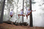 Dancers jumping in forest