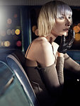 Woman wearing leather glove in car