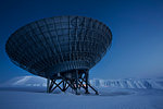 Satellite dish in snow-covered field